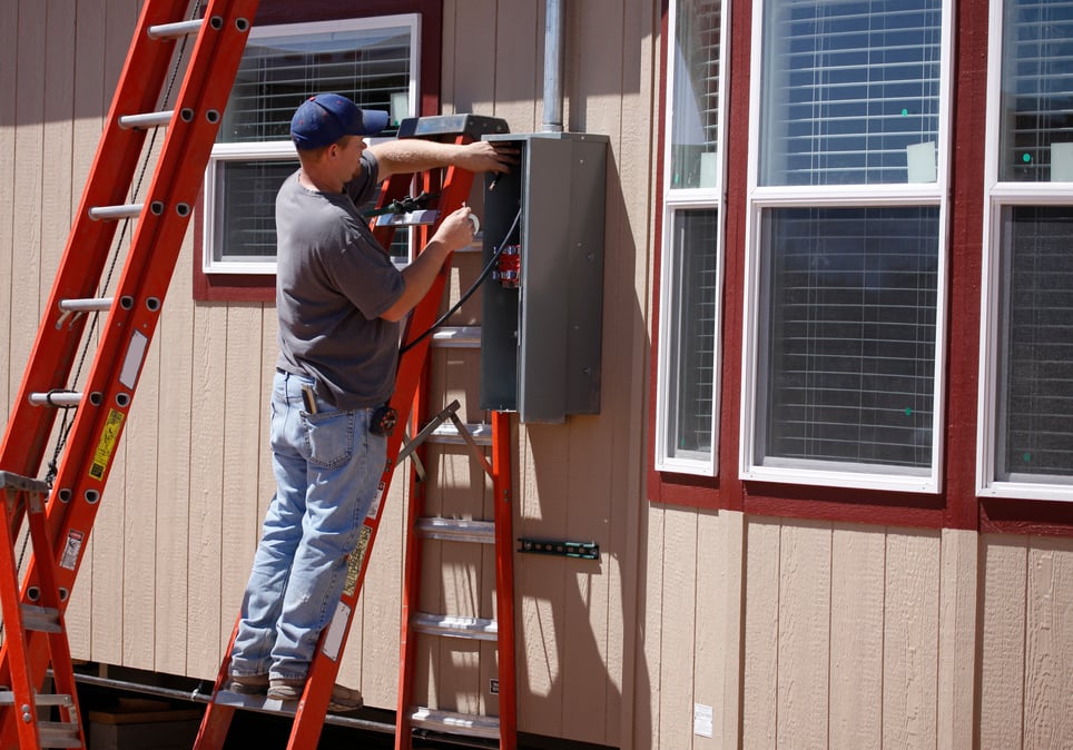 Electrician Working on Electrical Service Panel